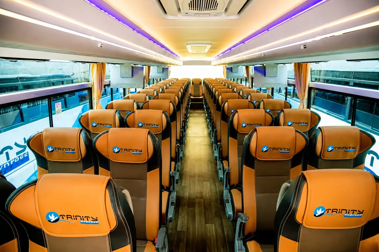 Wide view of a Trinity Express coach cabin and passenger seats