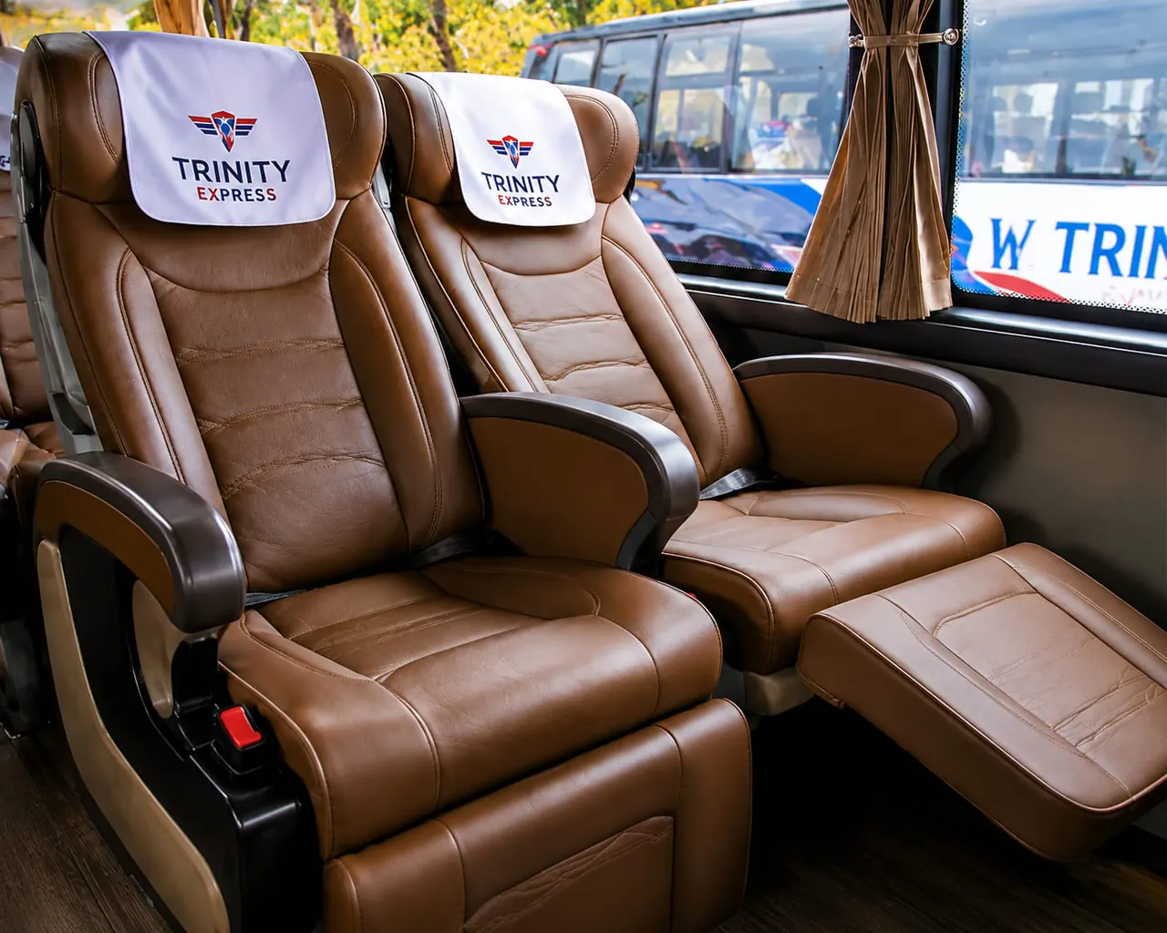Brown reclining Trinity Express executive coach seats with leg rests